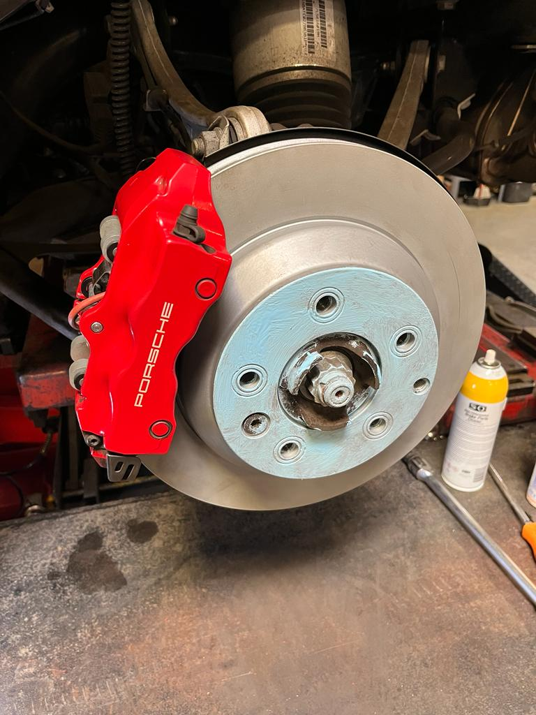 Porsche Cayenne front brake rotor and caliper after brake pad replacement