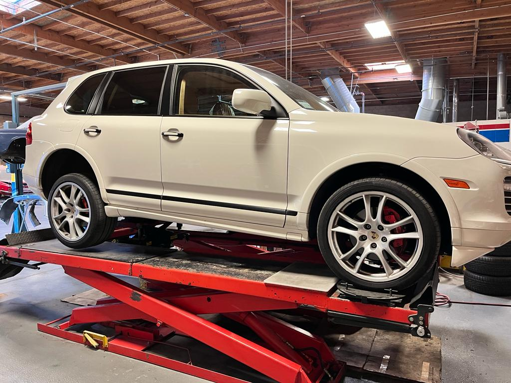 Porsche Cayenne on lift during brake pad replacement