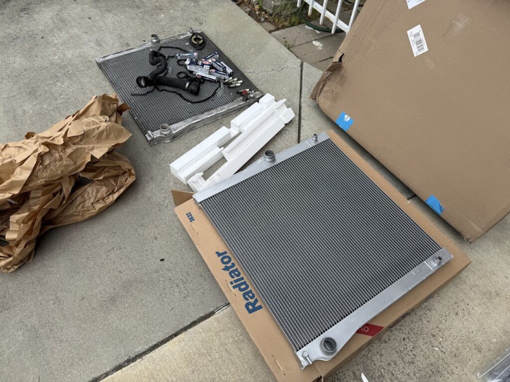 "Old and new Subaru radiator comparison before installation