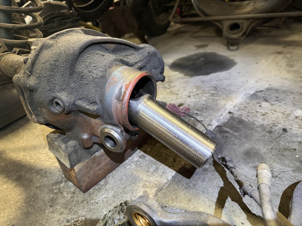Mercedes SL190 differential pinion shaft and rear axle housing during repair in workshop