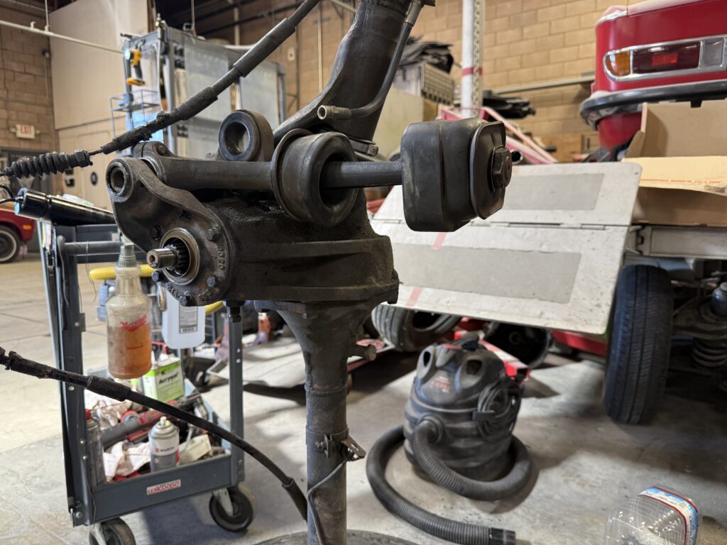 Mercedes SL190 rear suspension bushing and control arm mount close-up during repair and restoration