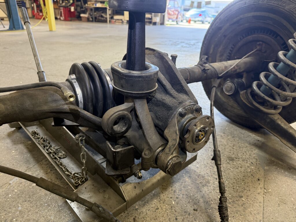 Mercedes SL190 rear differential close-up during repair with suspension and axle components removed
