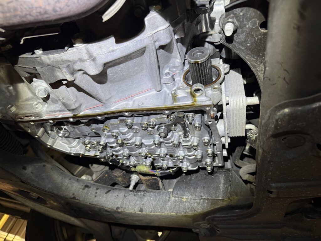 engine oil filter installed during oil change service with internal components exposed for maintenance