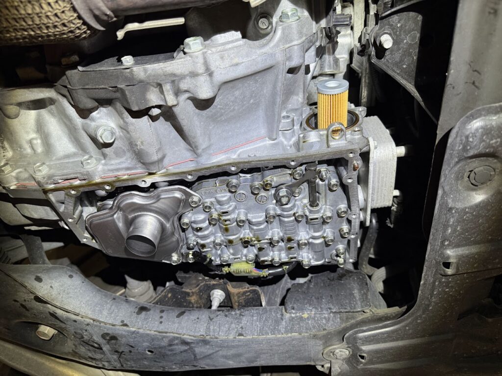 new oil filter installed and engine components reassembled after oil change service